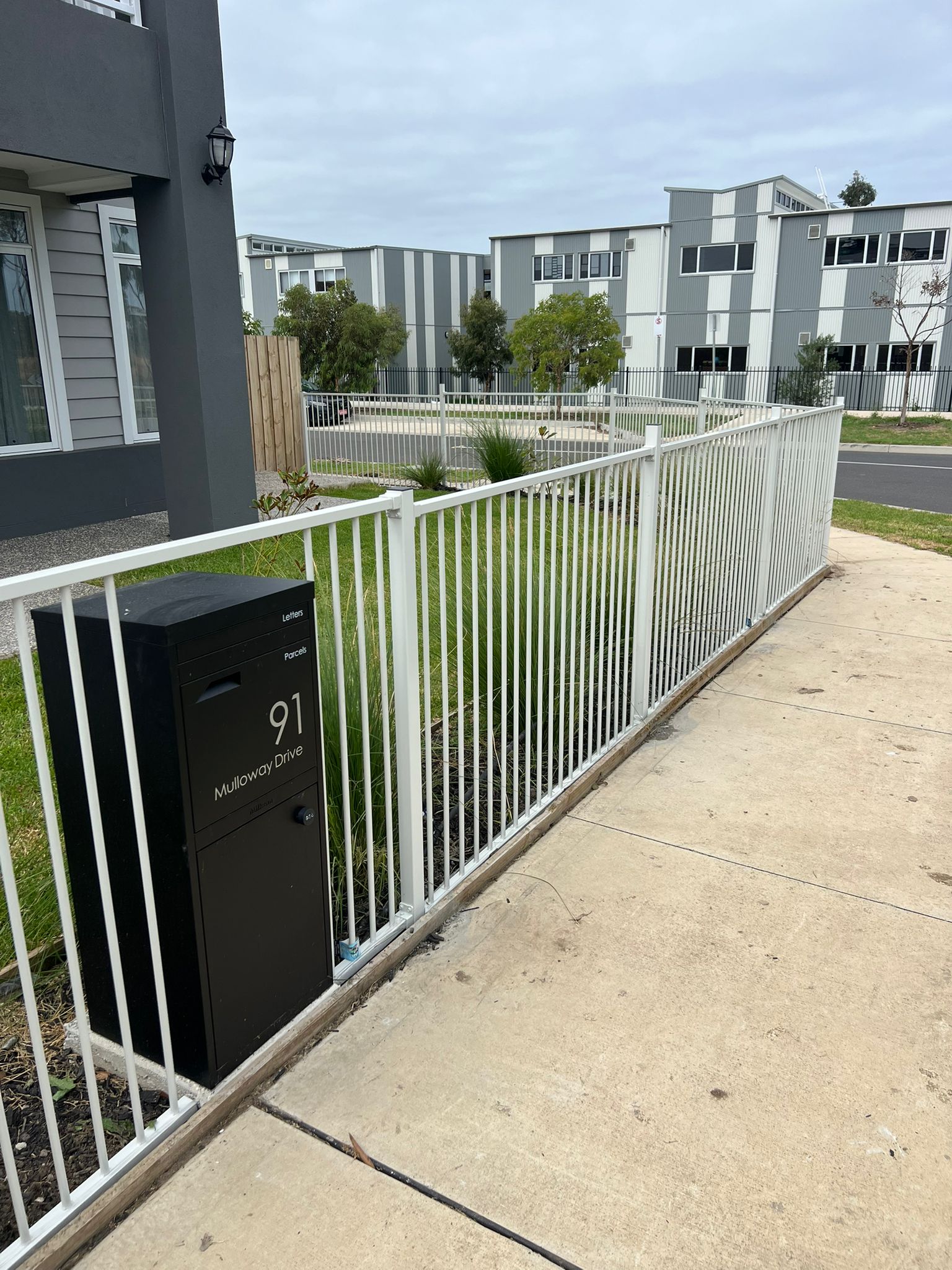 White tubular aluminium pool-style boundary fence, Tarneit