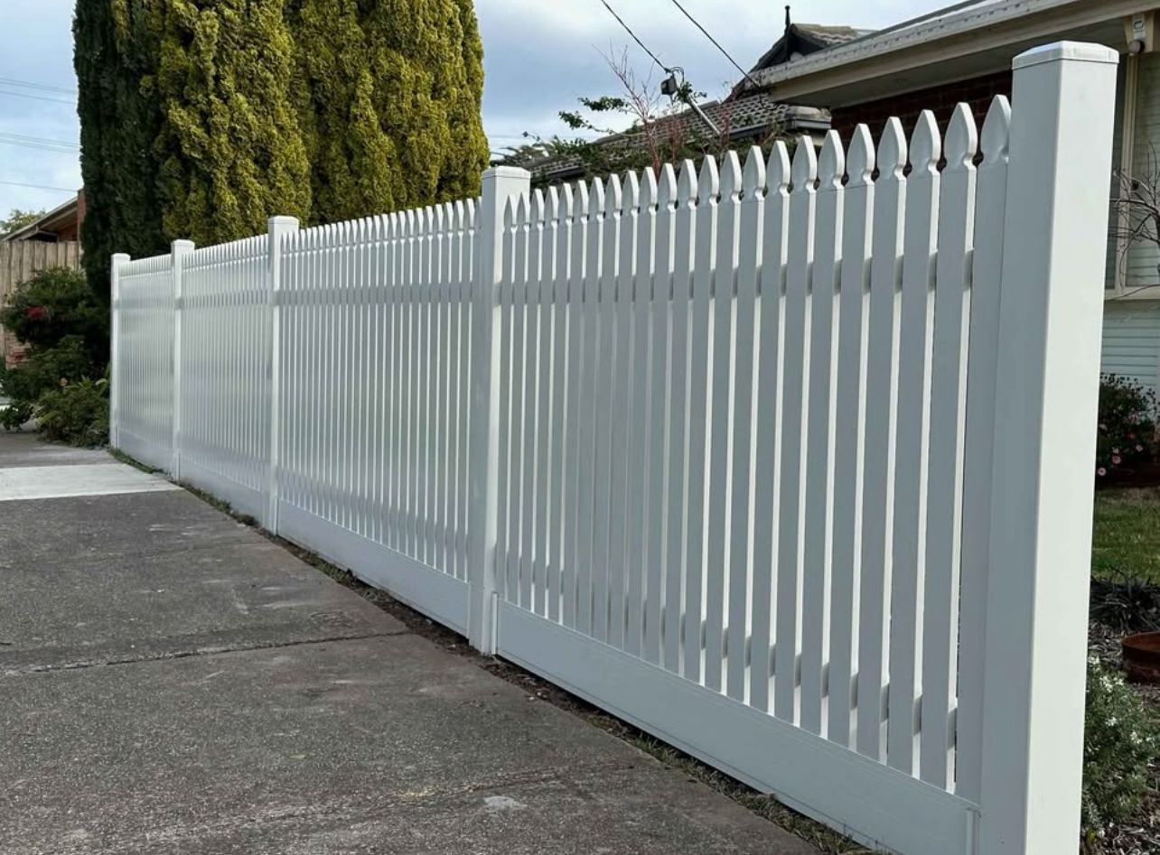 Custom white picket fence with scalloped tops